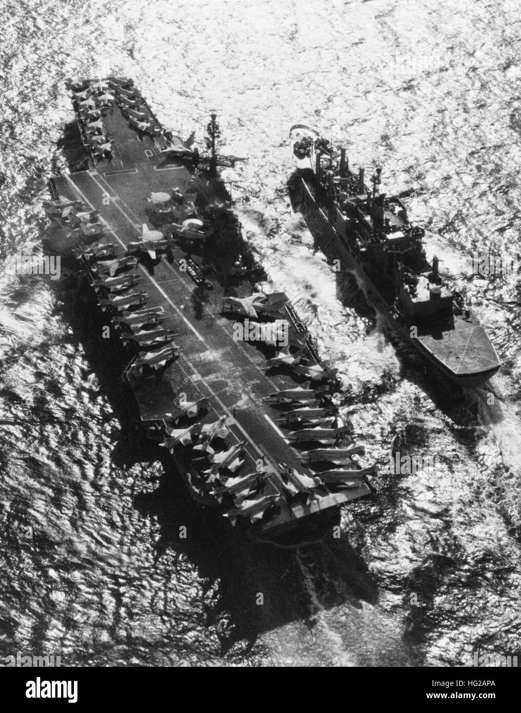 USS Niagara Falls (AFS-3) replenishes USS Coral Sea (CVA-43) in February 1970 Stock Photo