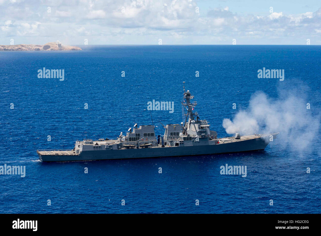 160615-N-SU278-1089 PACIFIC OCEAN (June 15, 2016) The guided-missile destroyer USS Spruance (DDG 111) fires it’s 5-inch gun at a targeting island during a joint-service targeting and bombing exercise with the U.S. Air Force. Spruance, along with the guided-missile destroyers USS Momsen (DDG 92) and USS Decatur (DDG 73), and embarked “Devil Fish” and “Warbirds” helicopter detachments of Maritime Strike Squadron 49 are deployed in support of maritime security and stability in the Indo-Asia-Pacific as part of a U.S. 3rd Fleet Pacific Surface Action Group (PAC SAG) under Commander, Destroyer Squad Stock Photo