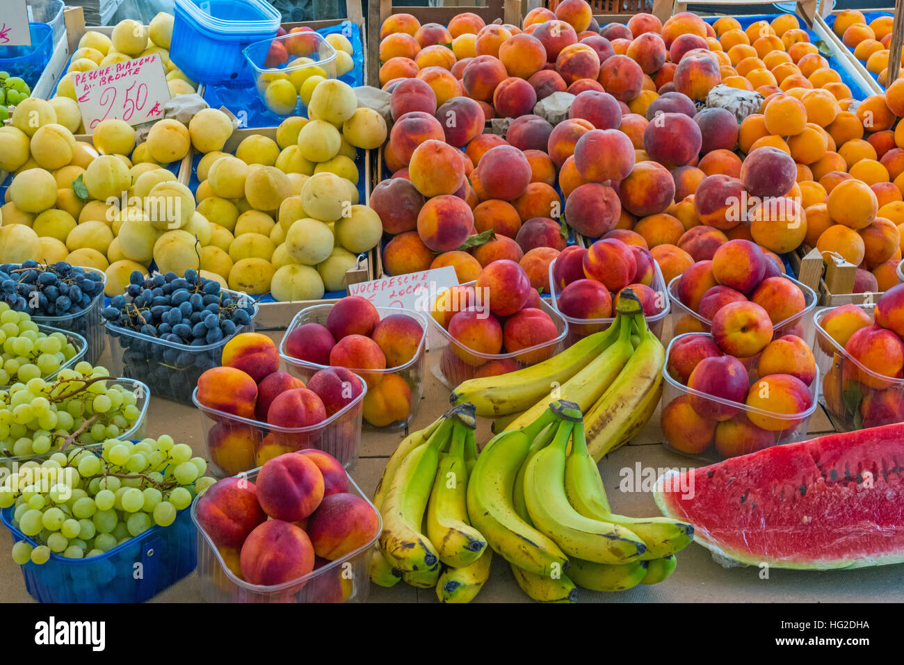 Different kinds of peaches and other fruits for sale at a market in