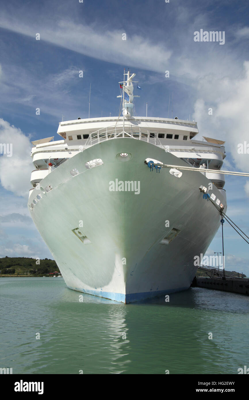 Large white cruise ship docked in the port with looking directly towards the ships bow, St John's, Antigua, Caribbean. Stock Photo