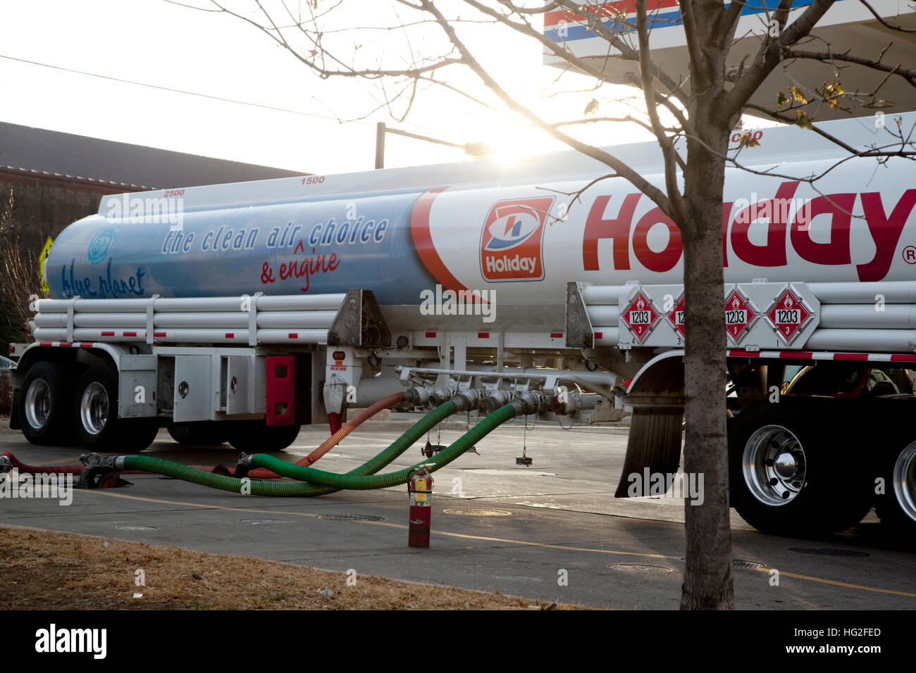 Filling Holiday gas station storage tanks with gasoline from a transport tanker. St Paul Minnesota MN USA Stock Photo