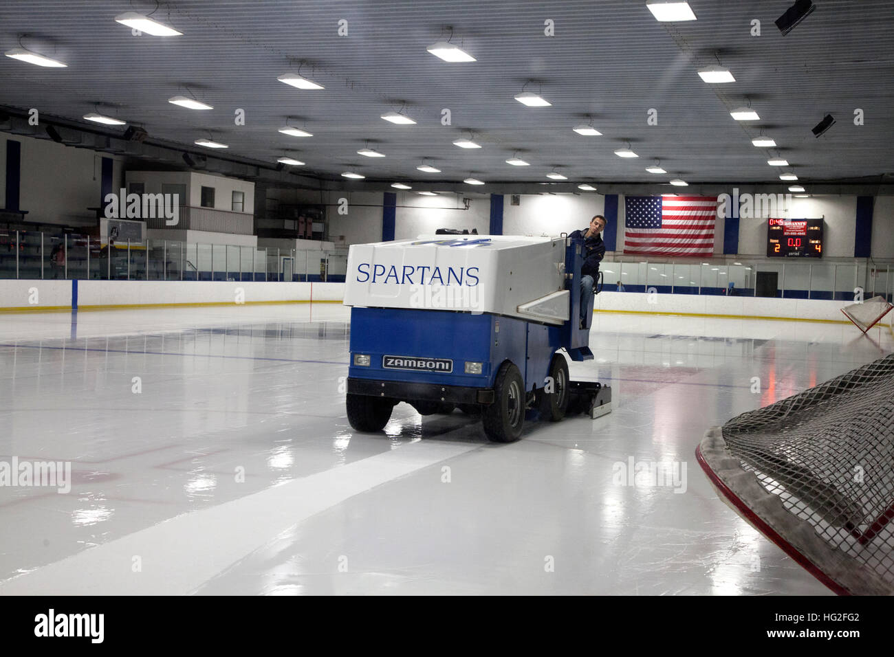 Zamboni repairing rutted ice from hockey game note American flag on