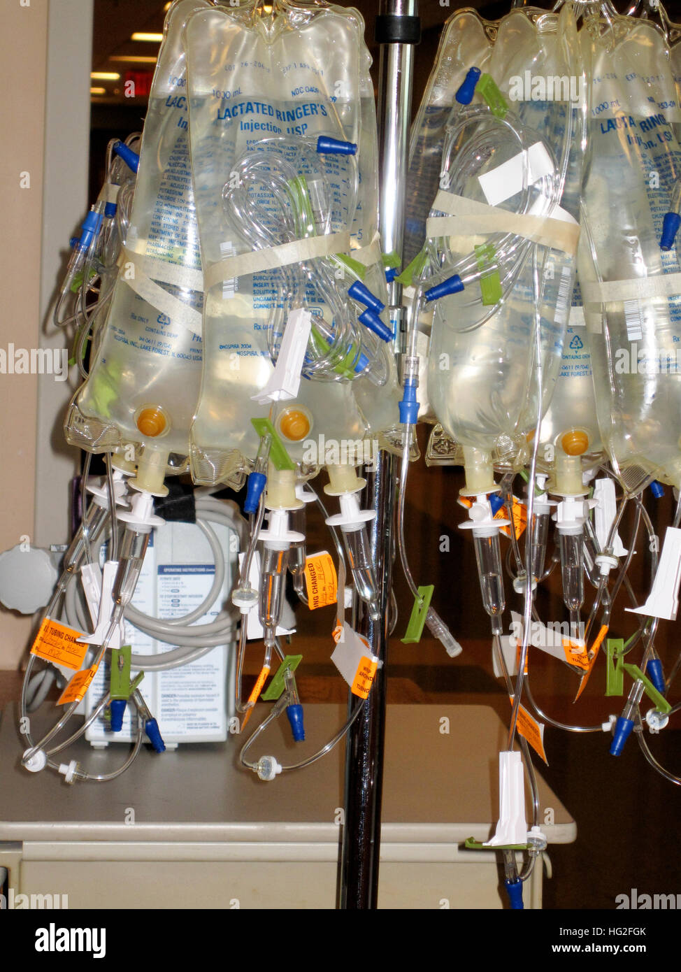 Intervenes bags of Lactated Ringer's solution hanging from a dispenser hook in a hospital. St Paul Minnesota MN USA Stock Photo