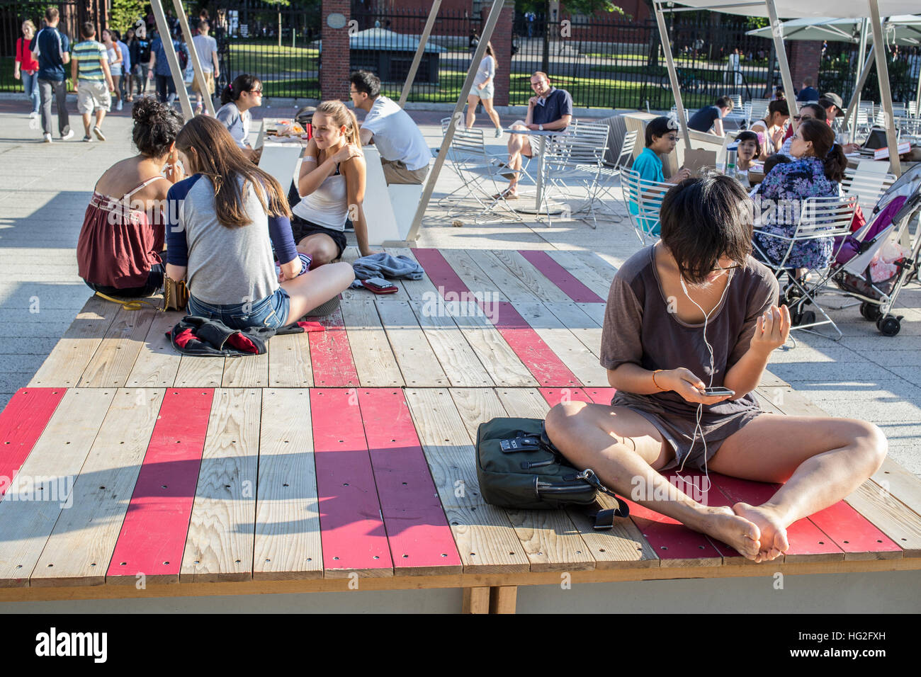 Student using her cell phone in Harvard Square, Cambridge, MA Stock