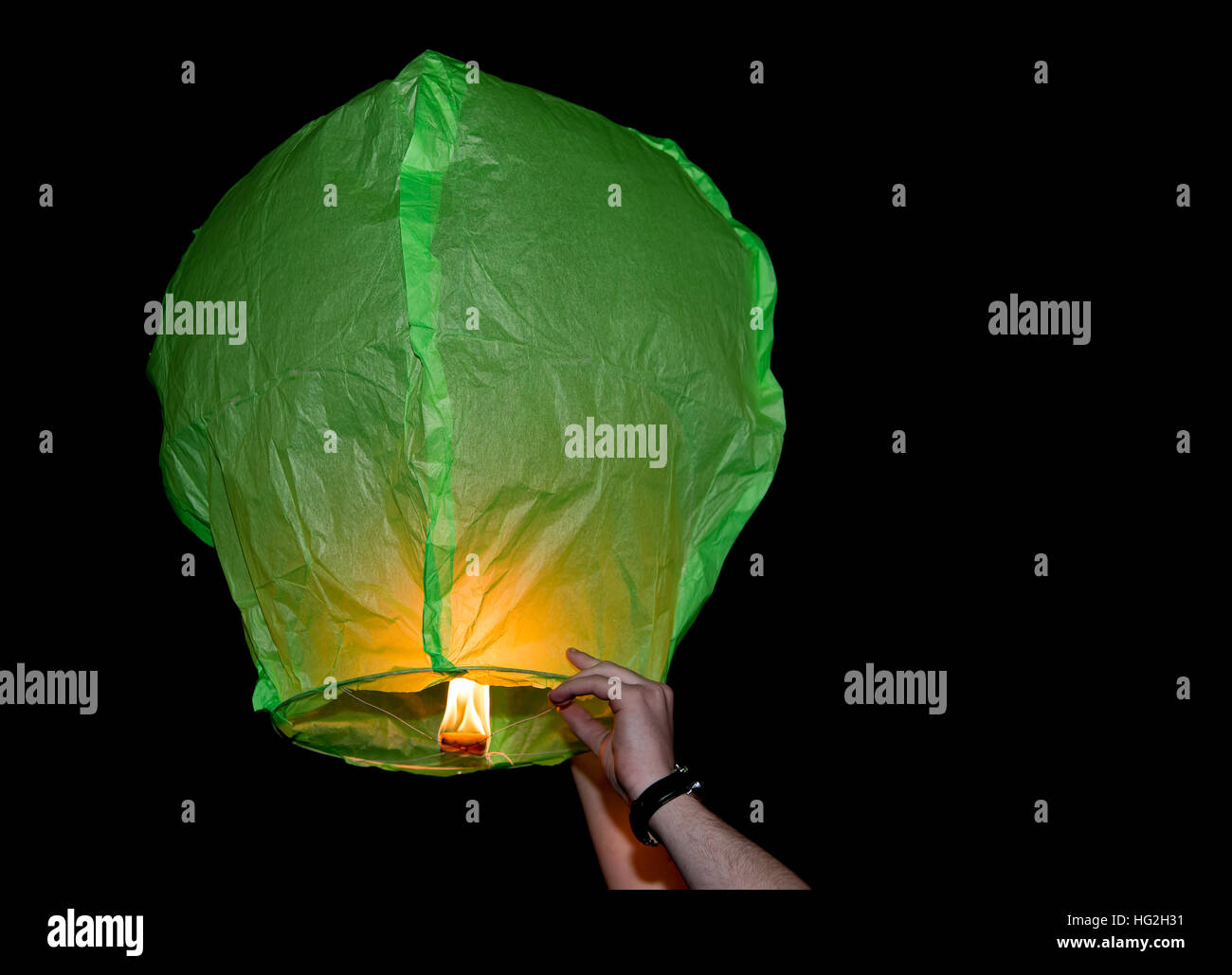 Green paper lantern being released into dark sky Stock Photo Alamy