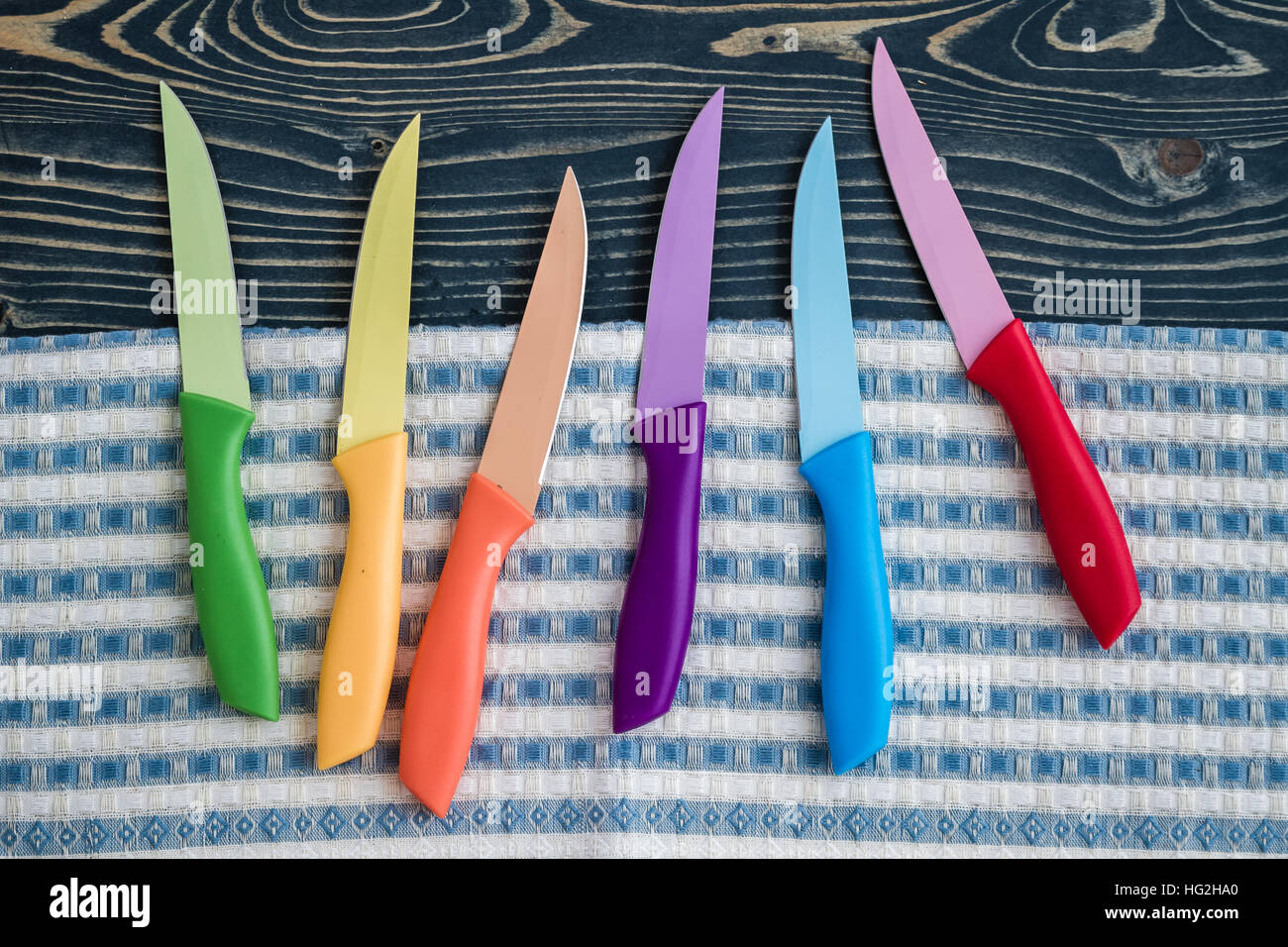 Set of Colorful Kitchen Knives on kitchen napkin Stock Photo