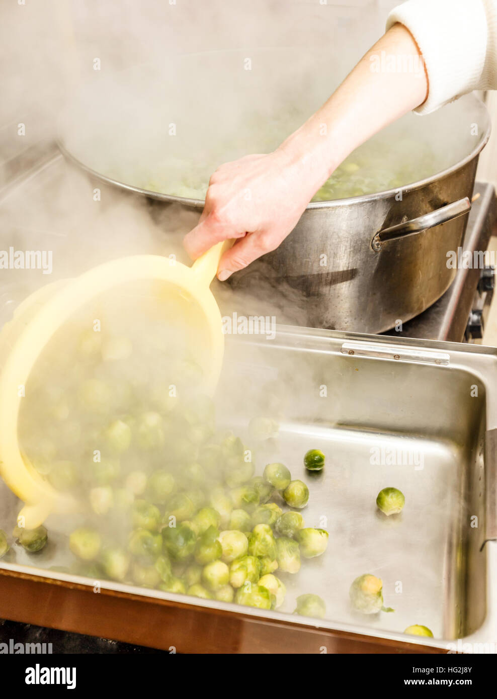Fried brussel sprouts, cooking progress in restaurant kitchen Stock Photo