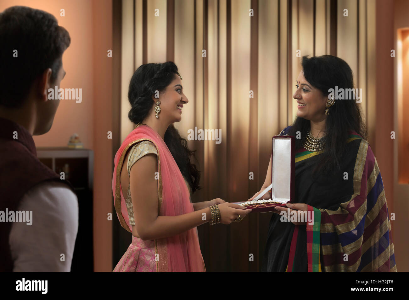 Mother gifting jewelry to her daughter on diwali Stock Photo