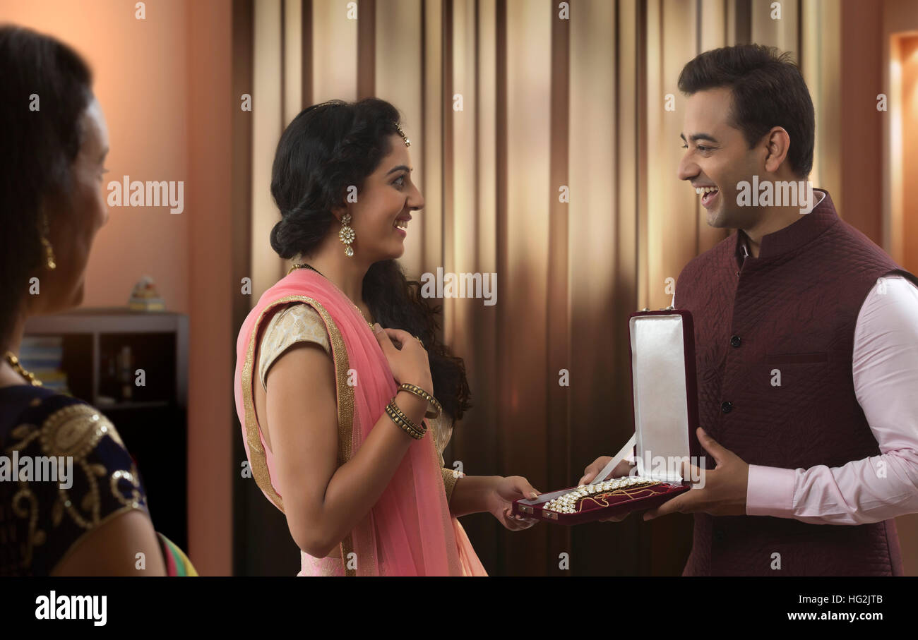 Young man giving jewellery box gift to young woman on diwali Stock Photo