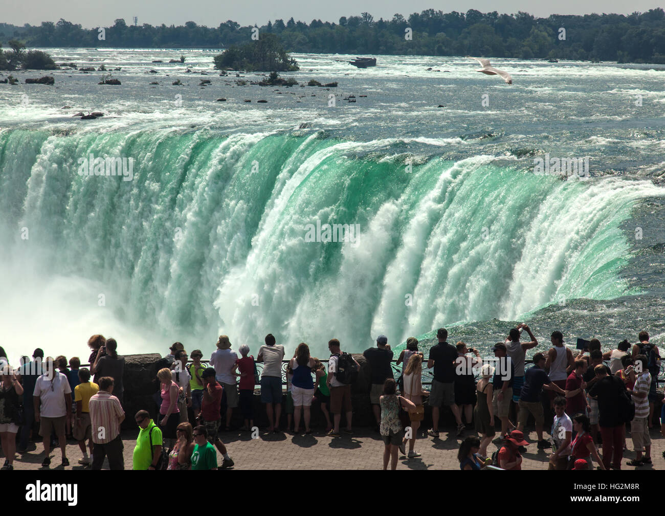 Tourists  on edge of Niagara Falls, taking photographs Stock Photo