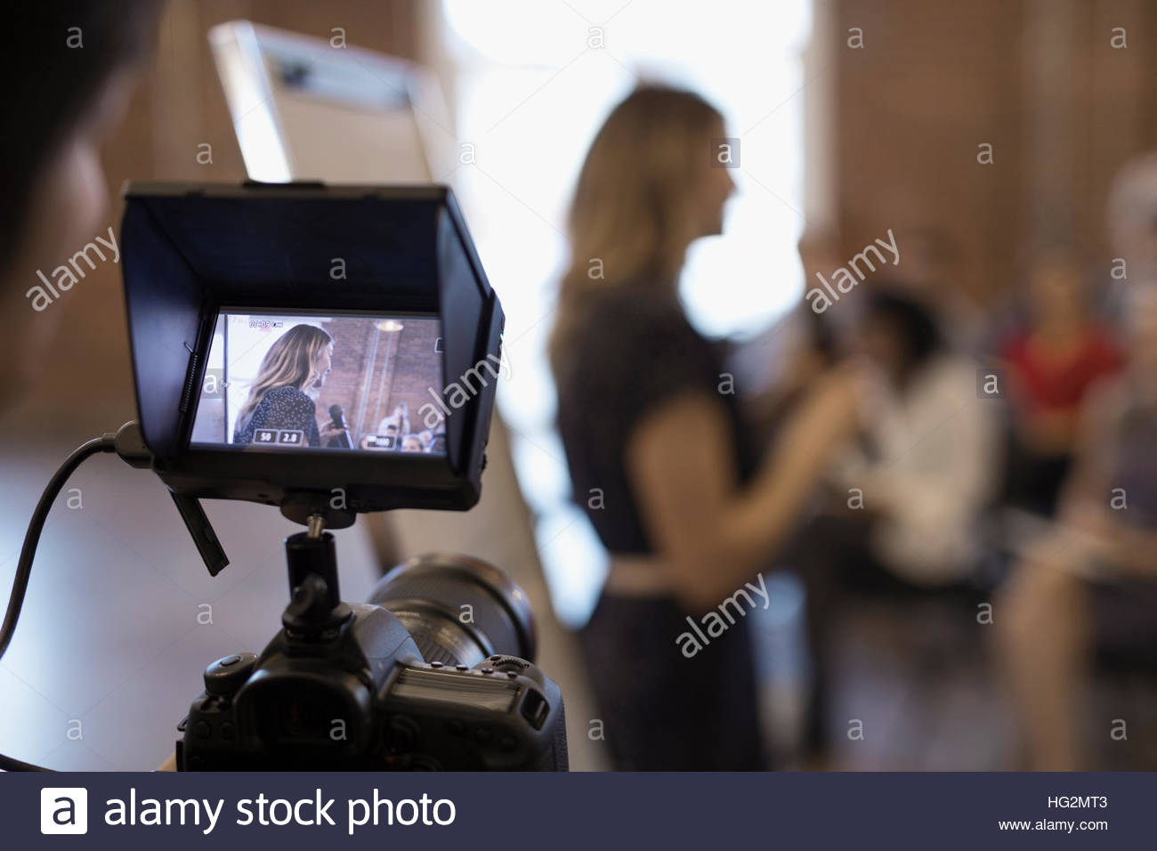 Digital viewfinder videoing of businesswoman leading conference meeting Stock Photo