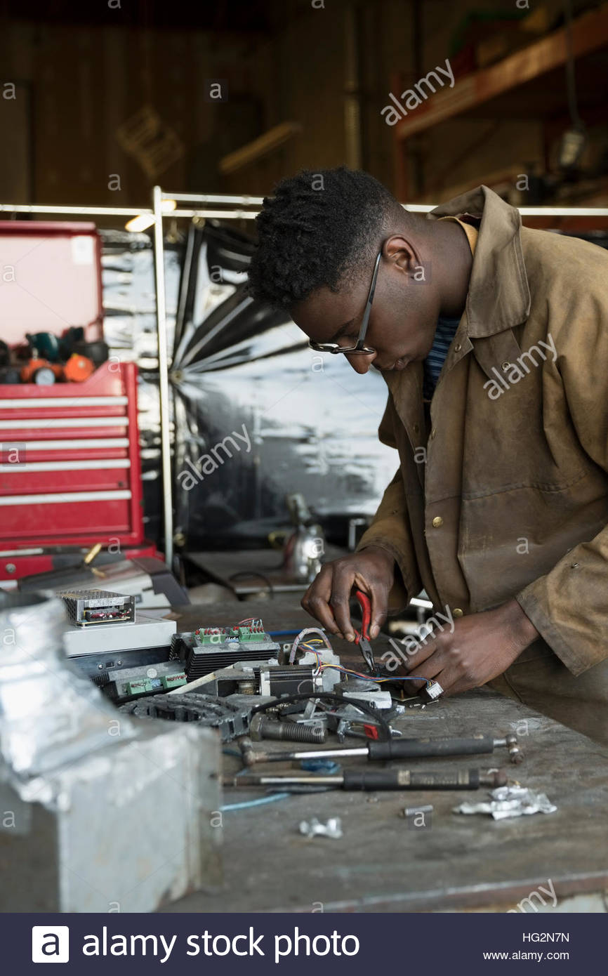Electronics engineer using tools at workbench Stock Photo Alamy