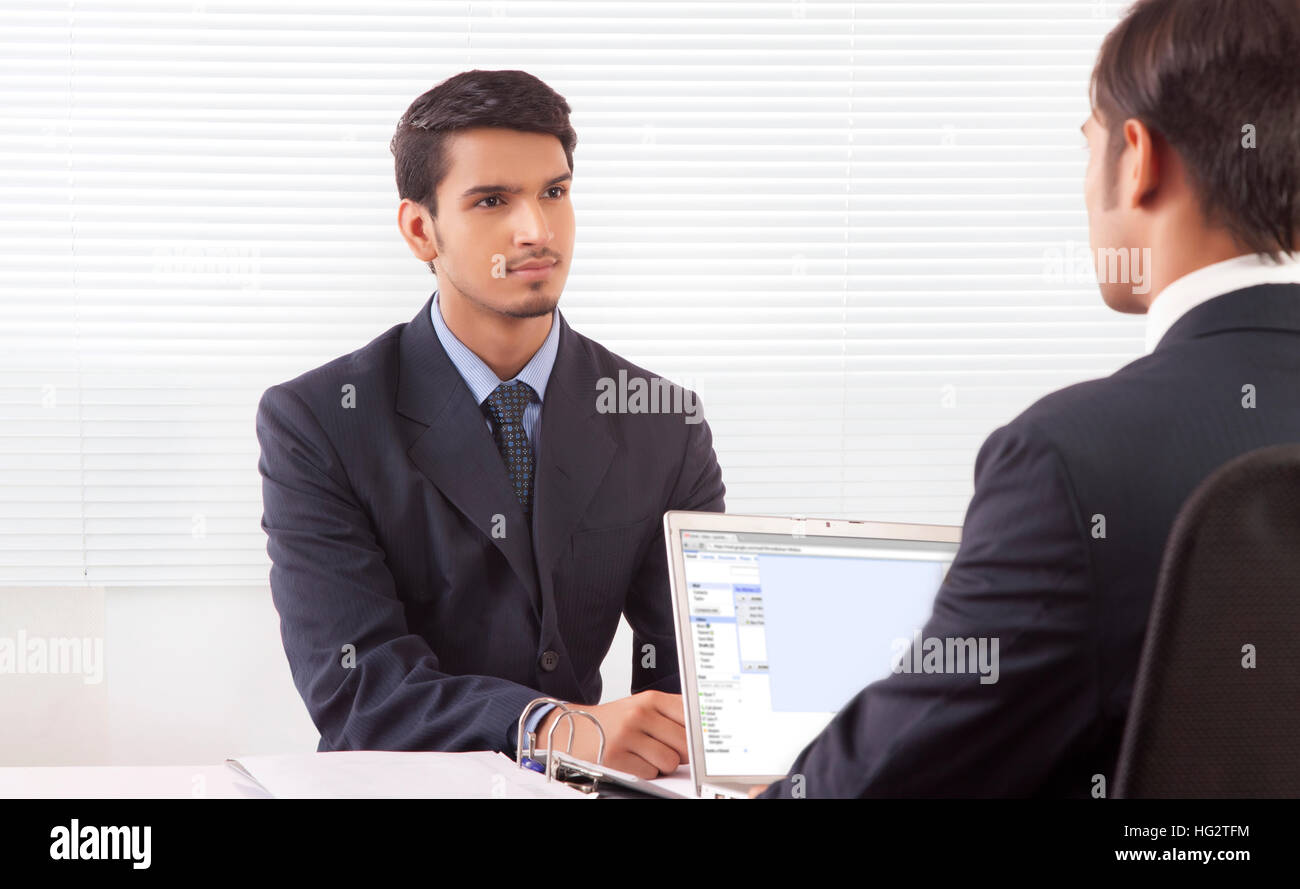 Two businessmen discussing work at office Stock Photo