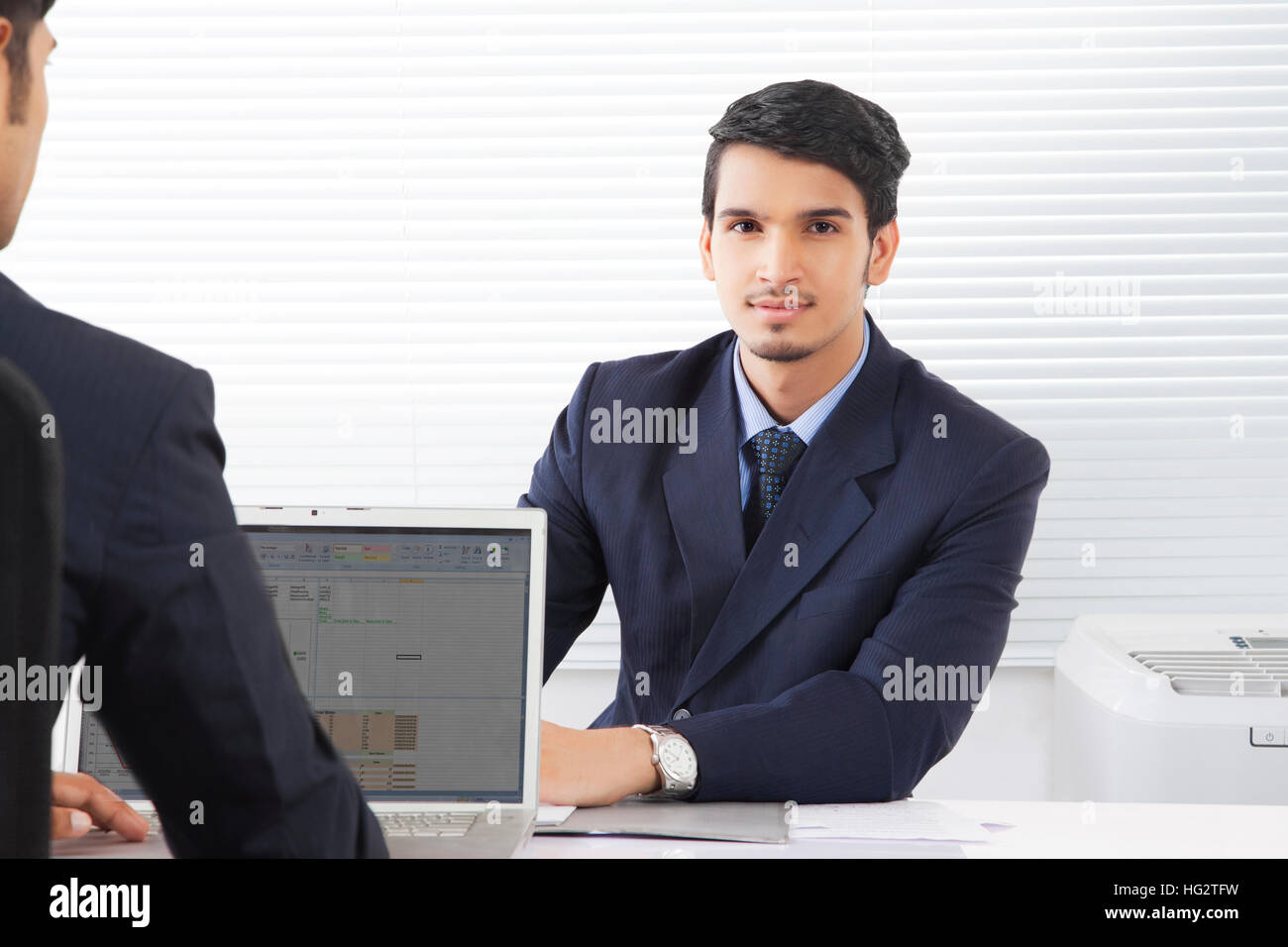 Two businessmen discussing work at office Stock Photo