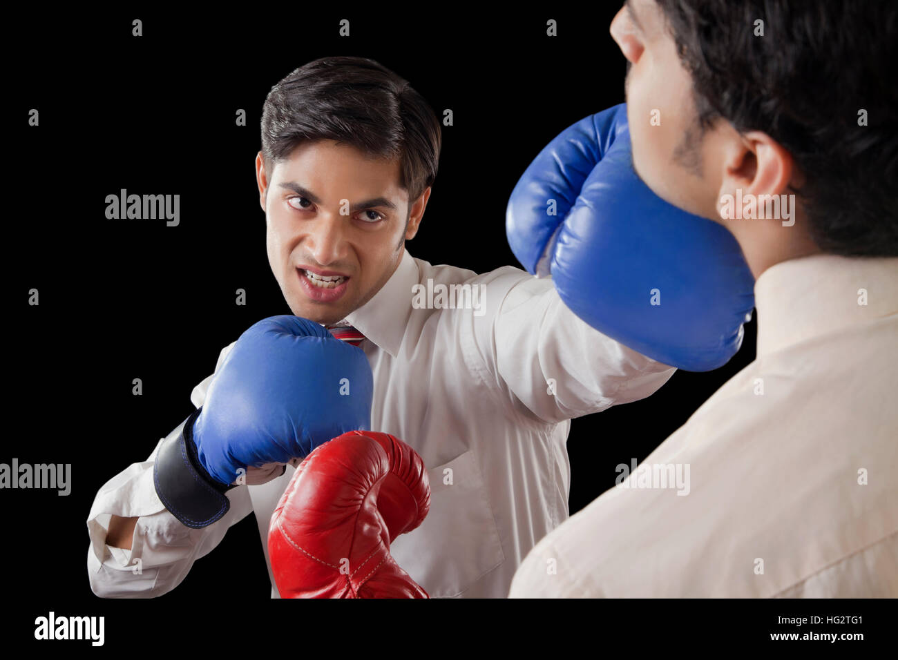Businessmen fighting in boxing ring Stock Photo