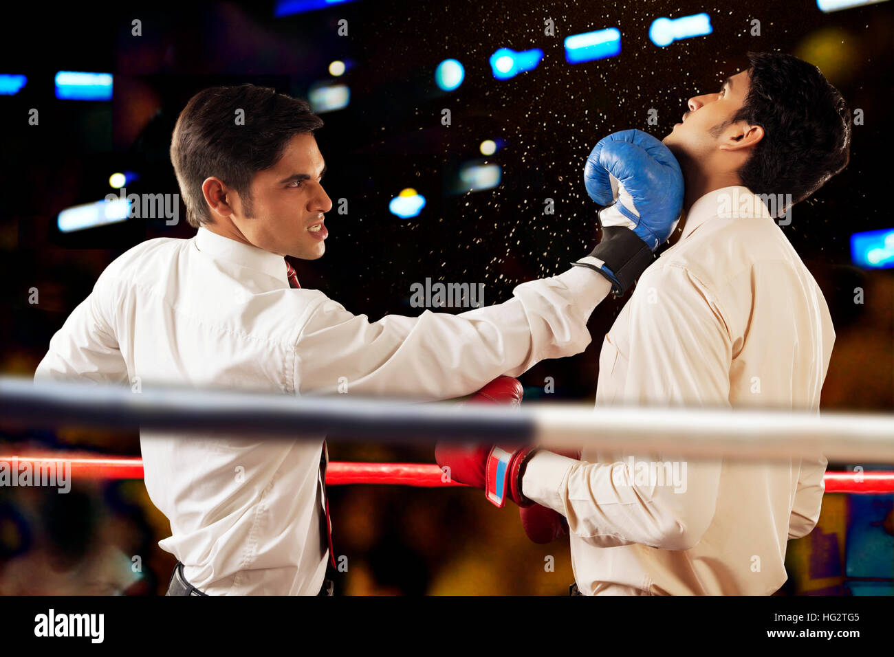 Businessmen fighting in boxing ring Stock Photo