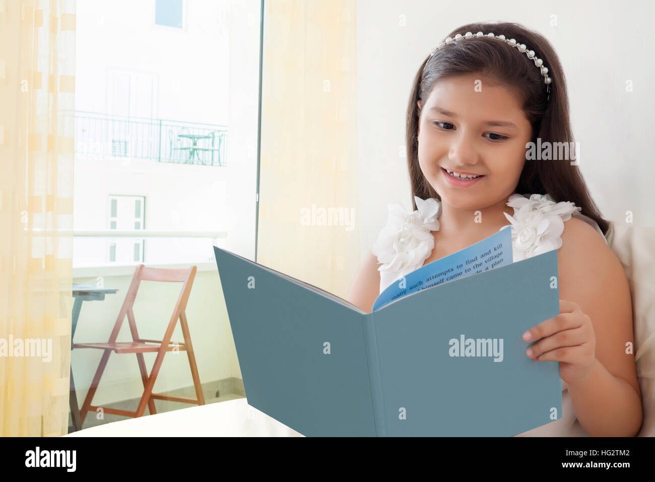 Indian girl reading book bed hi-res stock photography and images - Alamy