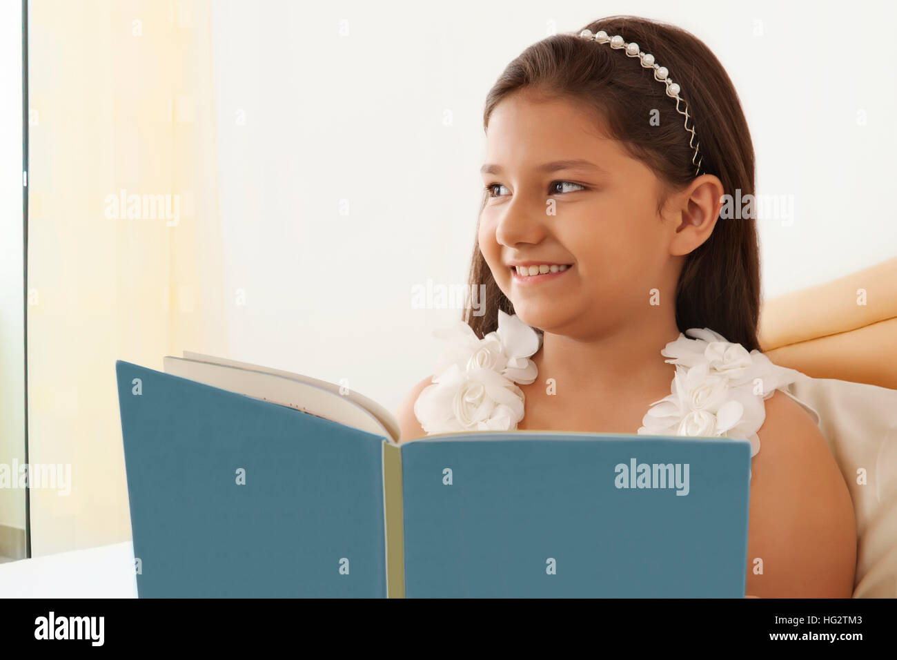 Indian girl reading book bed hi-res stock photography and images - Alamy