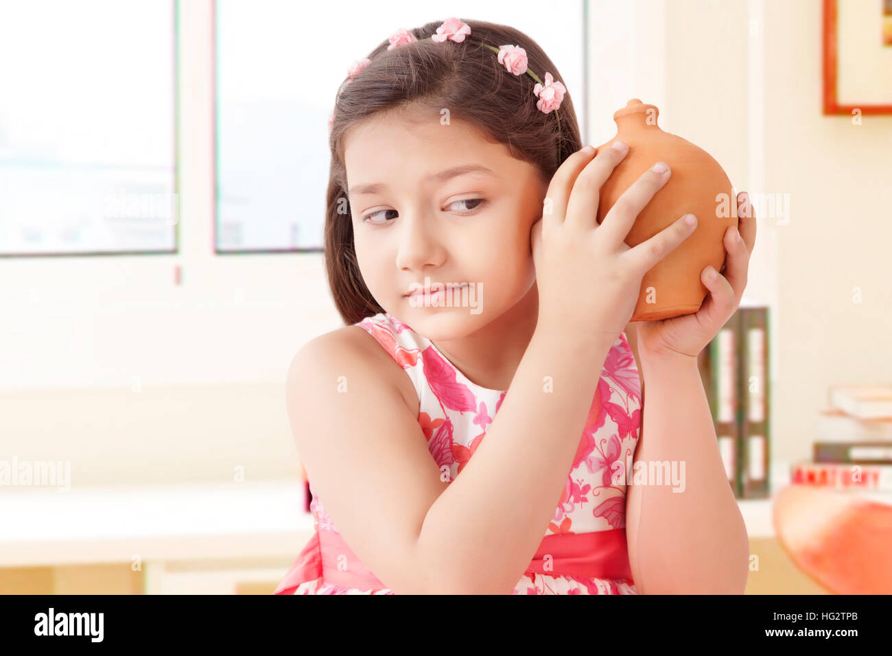 Girl holding clay piggy bank Stock Photo - Alamy