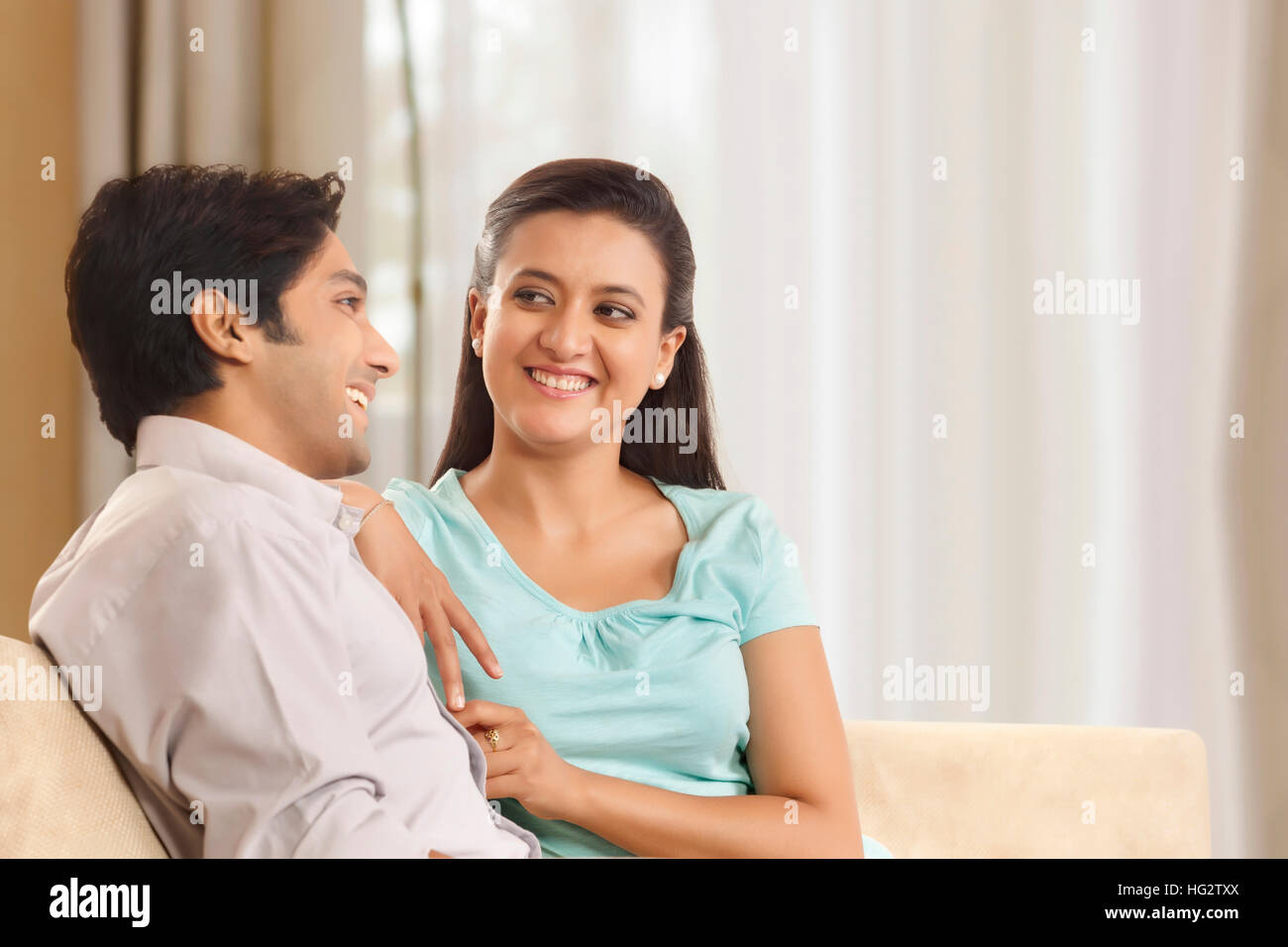 Portrait of smiling young couple at home Stock Photo - Alamy