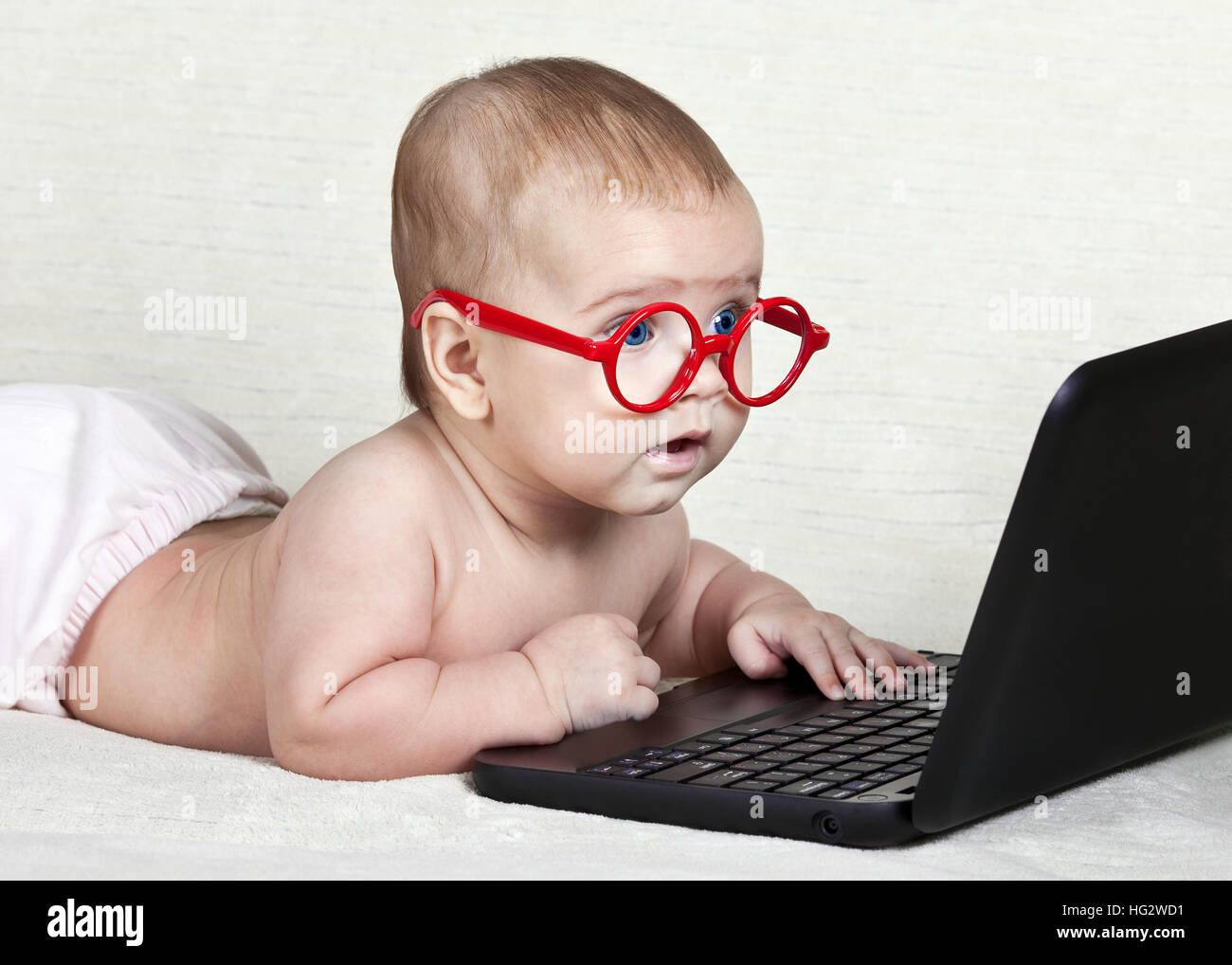 Funny kid with a laptop Stock Photo - Alamy