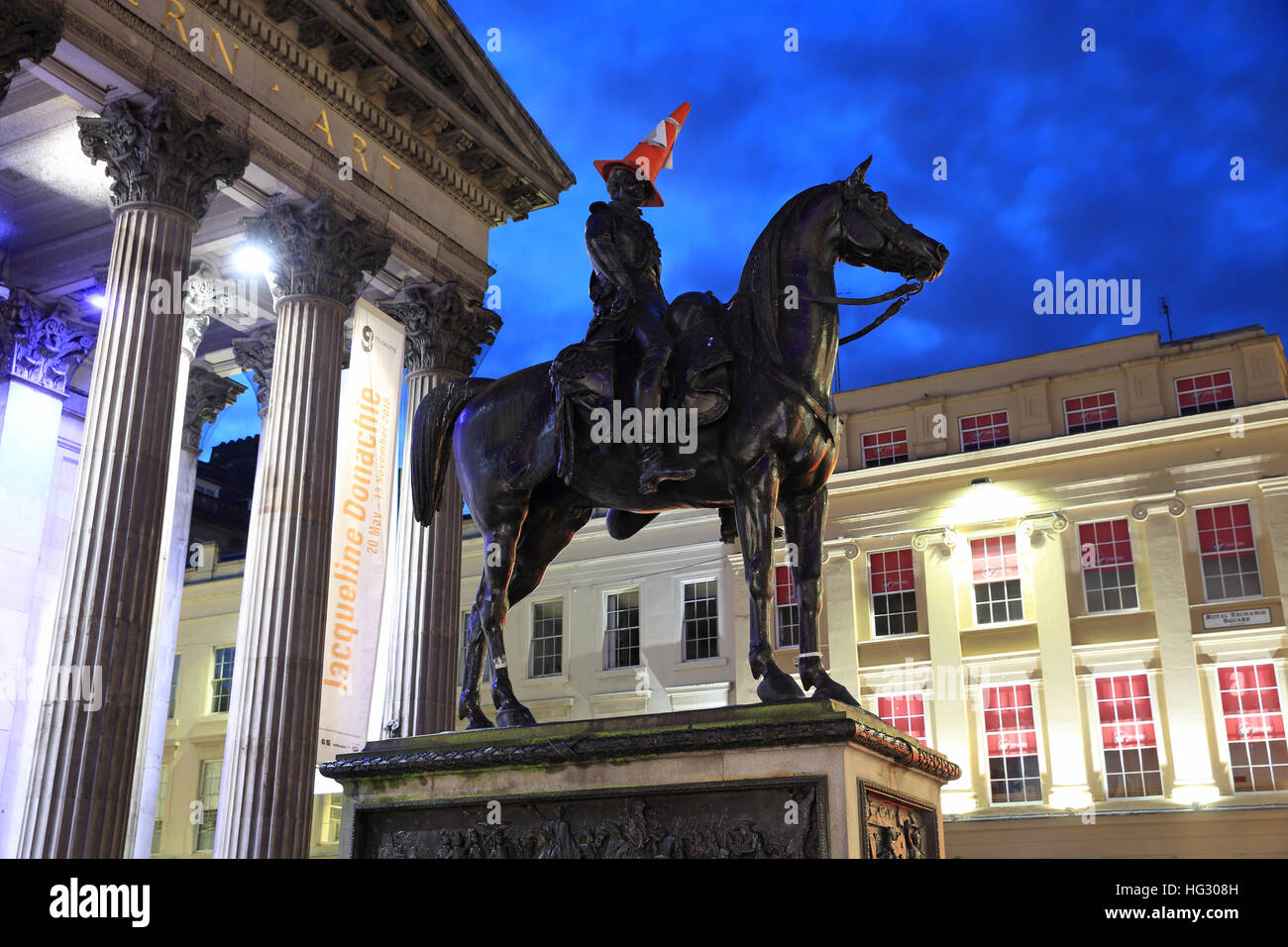 The iconic traffic cone on top of the Wellington statue in front of the Gallery of Modern Art, in Glasgow, Scotland, UK Stock Photo