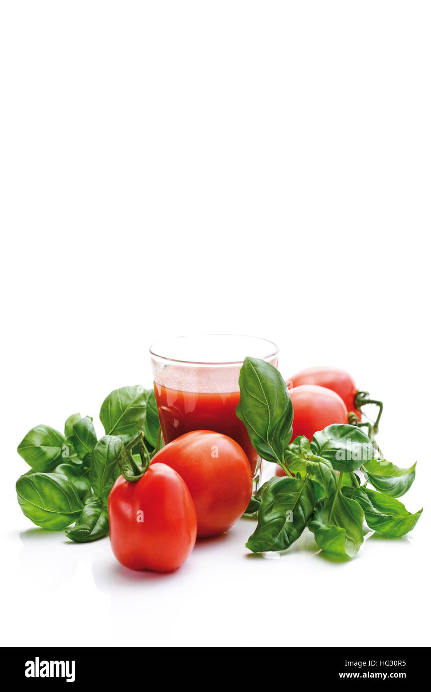 Plum tomatoes, Heirloom Tomato variety (Lycopersicon esculentum) and basil Stock Photo