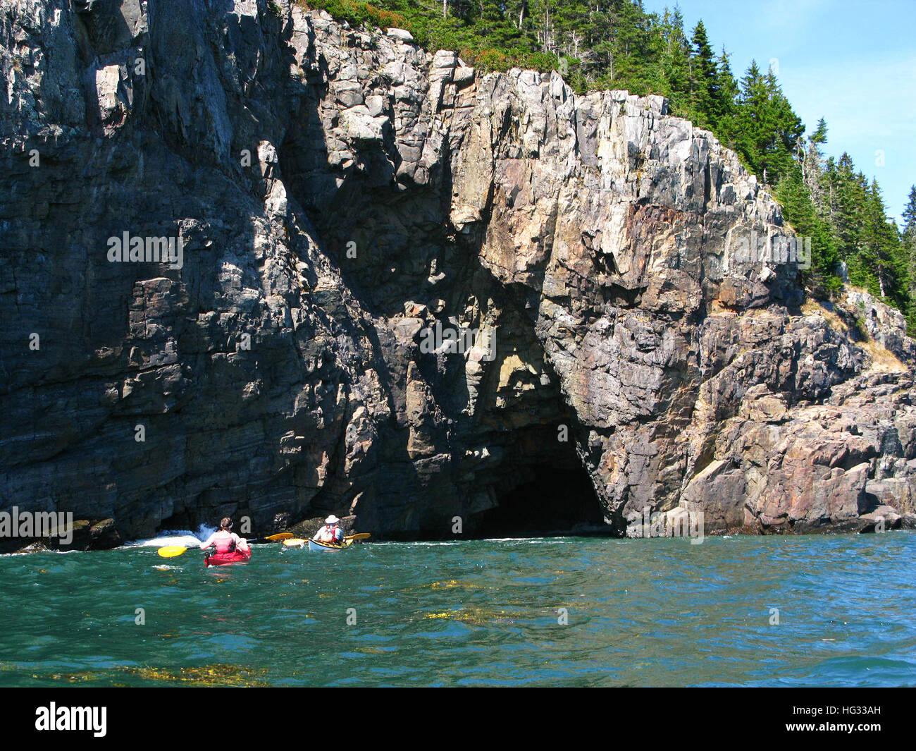Acadia National Park, Schoodic Peninsula. Sea kayaking off the cave at Ironbound Island, Winter Harbor, Maine Stock Photo