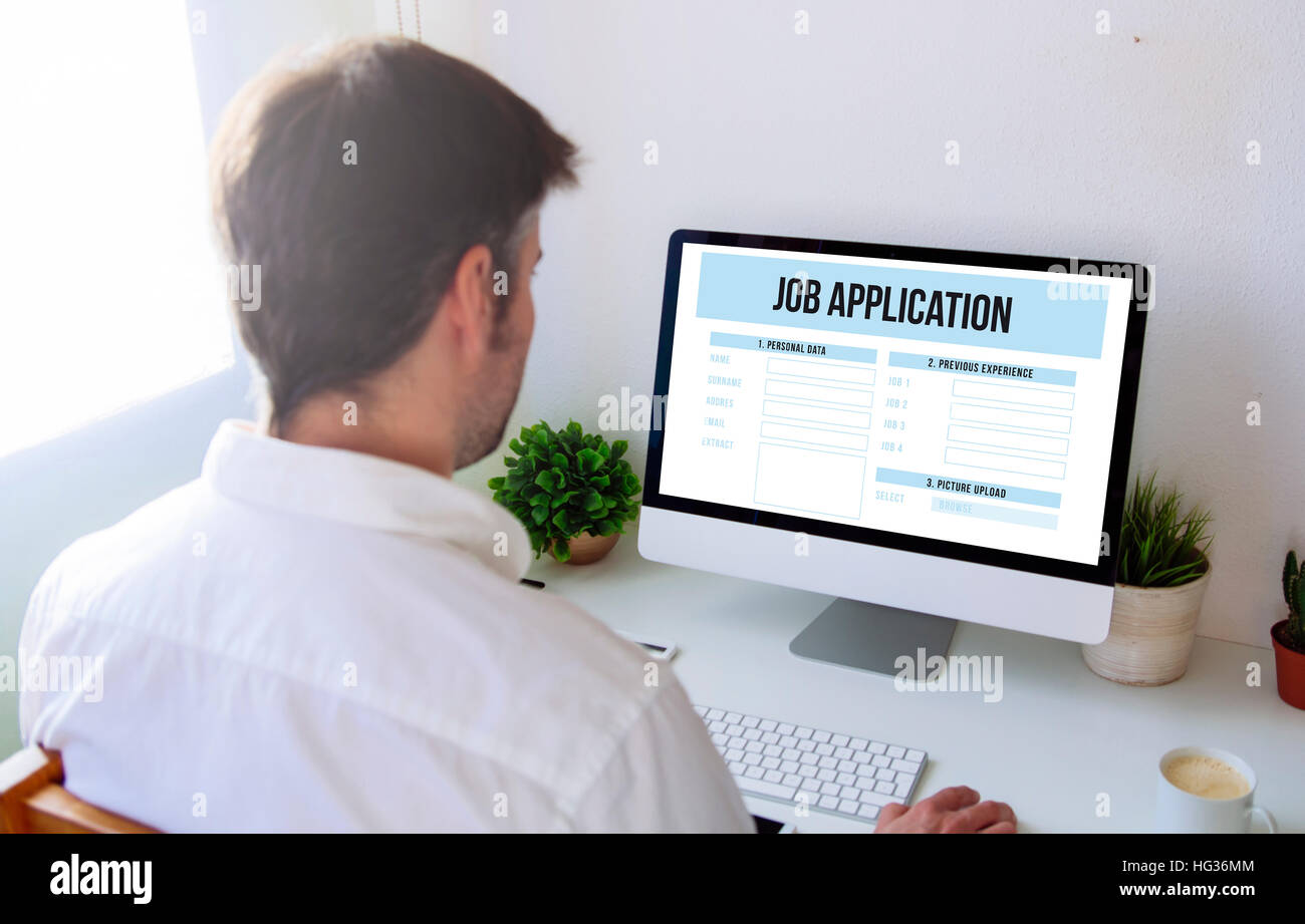 man applying for a job with computer. All screen graphics are made up. Stock Photo