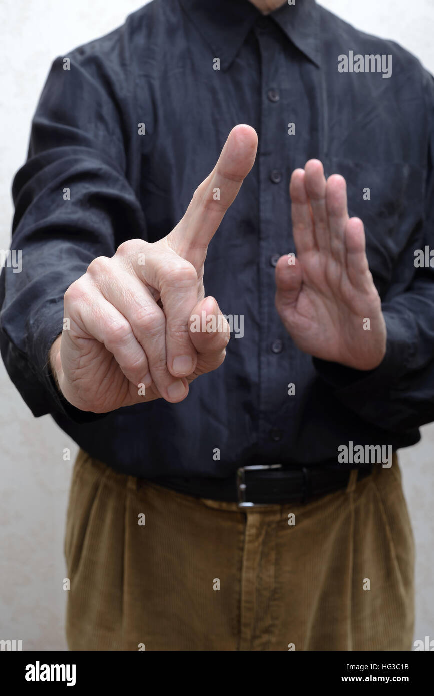 A man saying stop or no with a finger gesture. Refusing to take the bribe from corrupted people Stock Photo