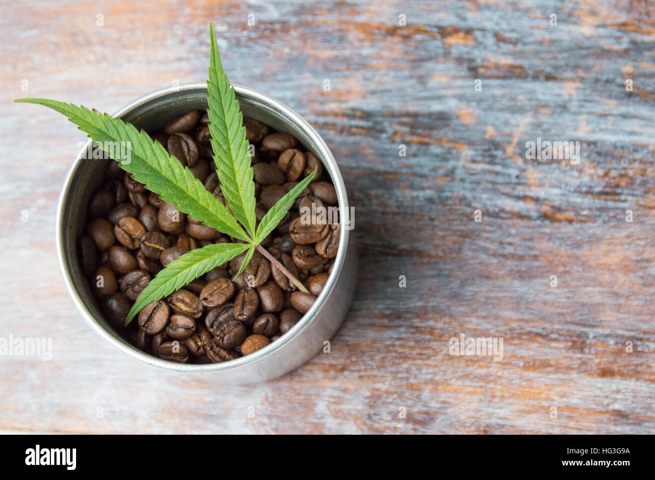 Marijuana leaf and roasted dark coffee beans Stock Photo