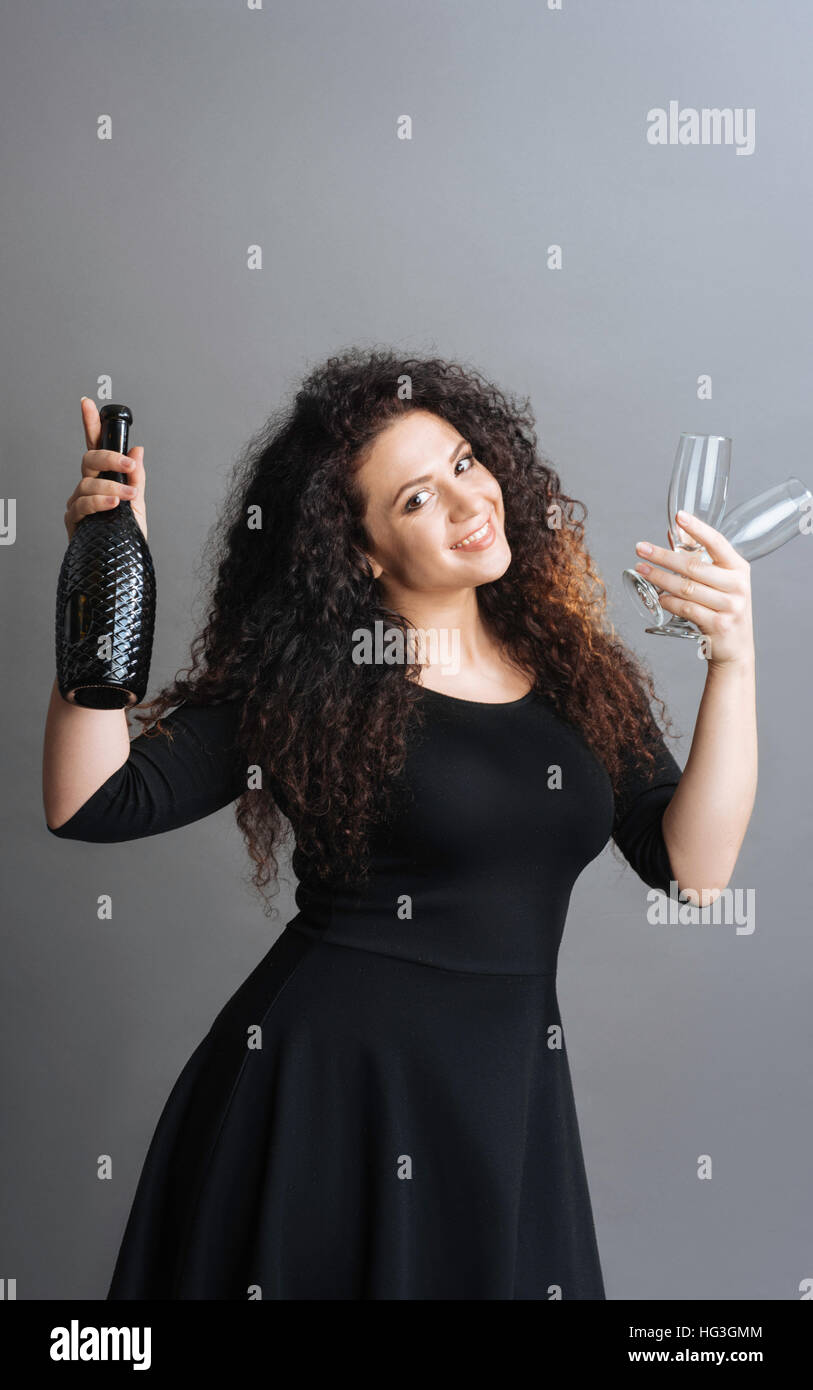 Beautiful female posing with bottle of wine Stock Photo - Alamy