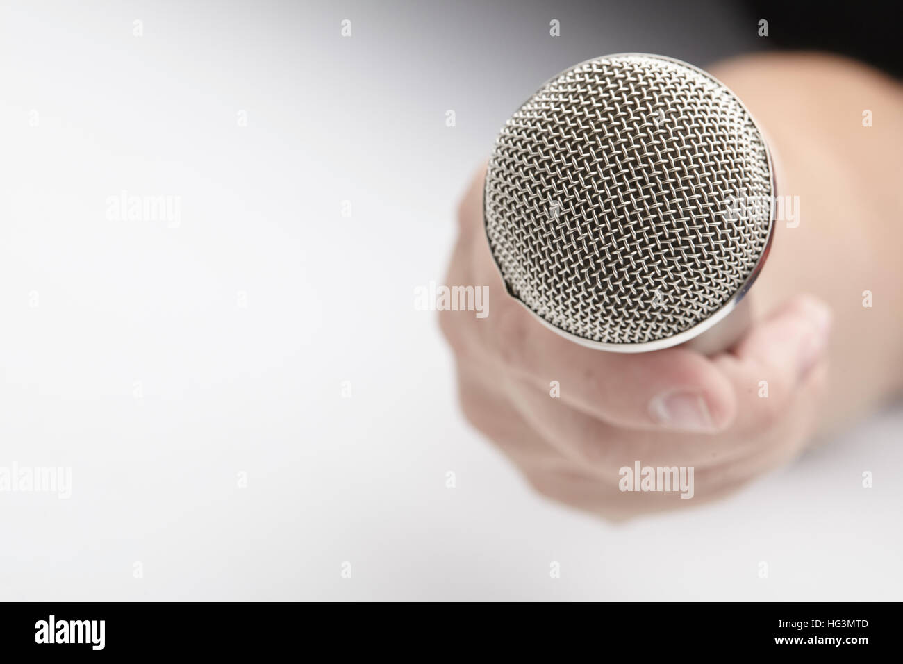Microphone in a man's hand Stock Photo - Alamy