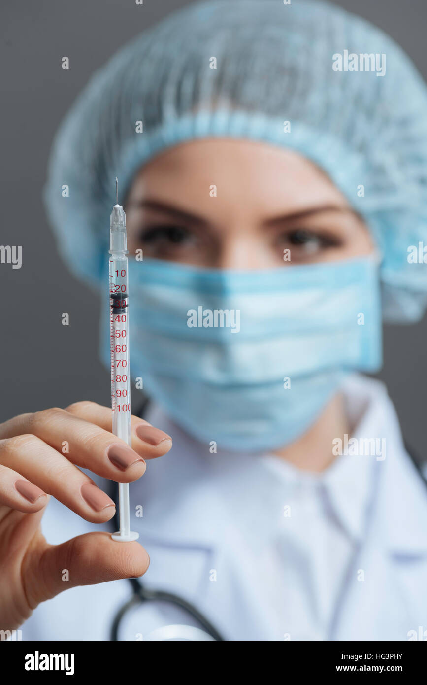 Close up of young doctor using hypodermic needle Stock Photo Alamy