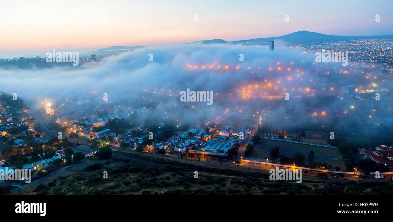 Early morning fog over the rising city of Queretaro Mexico. The aqueduct of Queretaro. Stock Photo