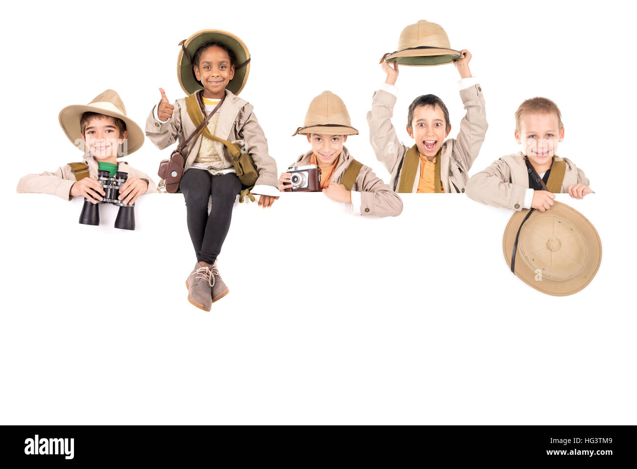 Children's group with safari clothes and gear over a white board Stock ...