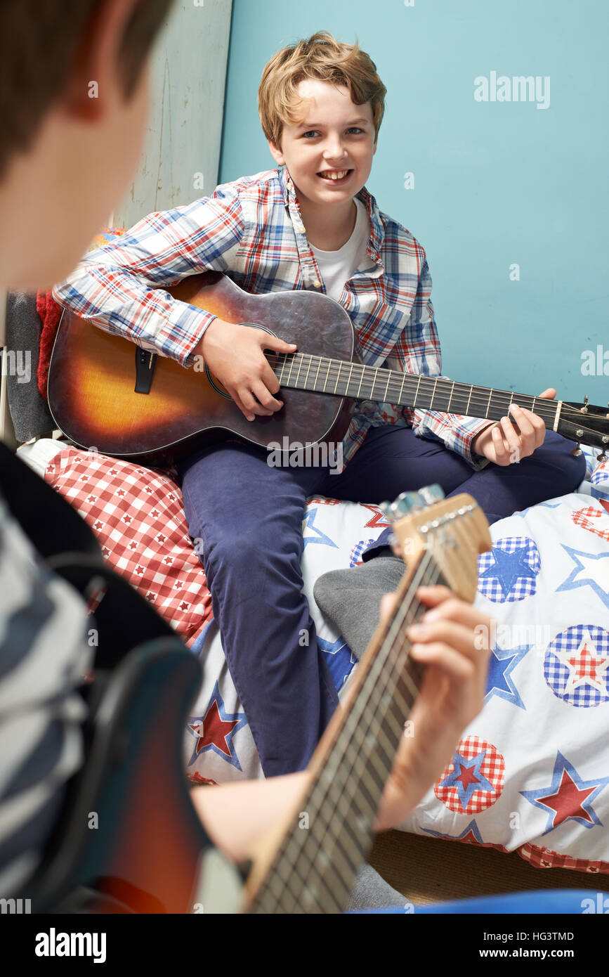Boys In Bedroom Playing Guitars Together Stock Photo Alamy