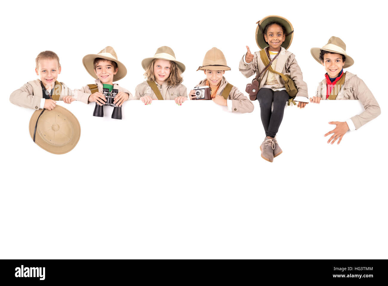 Children's group with safari clothes and gear over a white board Stock ...