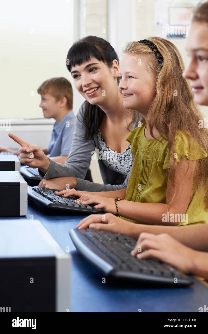 Female Elementary Pupil In Computer Class With Teacher Stock Photo - Alamy