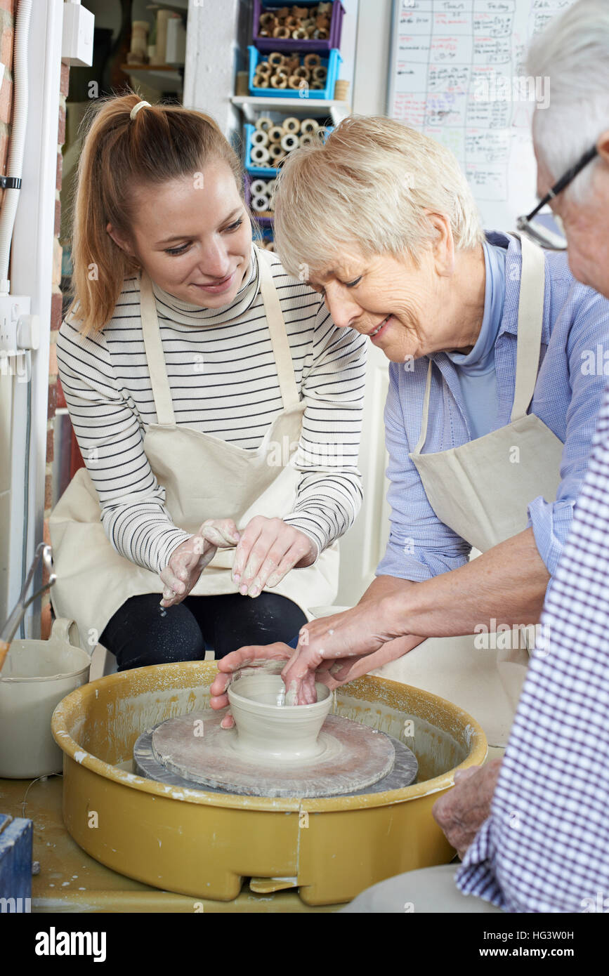 Seniors With Teacher In Pottery Class Stock Photo Alamy