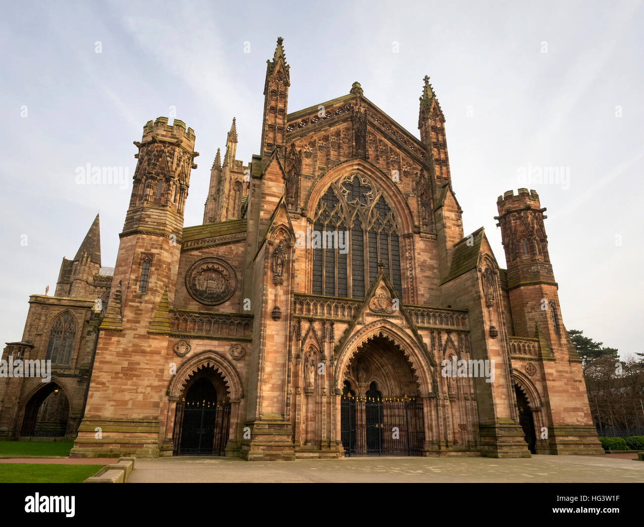 Hereford Cathedral building exterior west front lit by warm December sunlight. Stock Photo