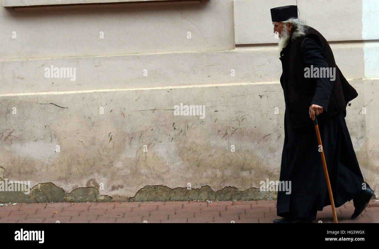 A Romanian Orthodox priest walking through the streets of Suceava. Stock Photo