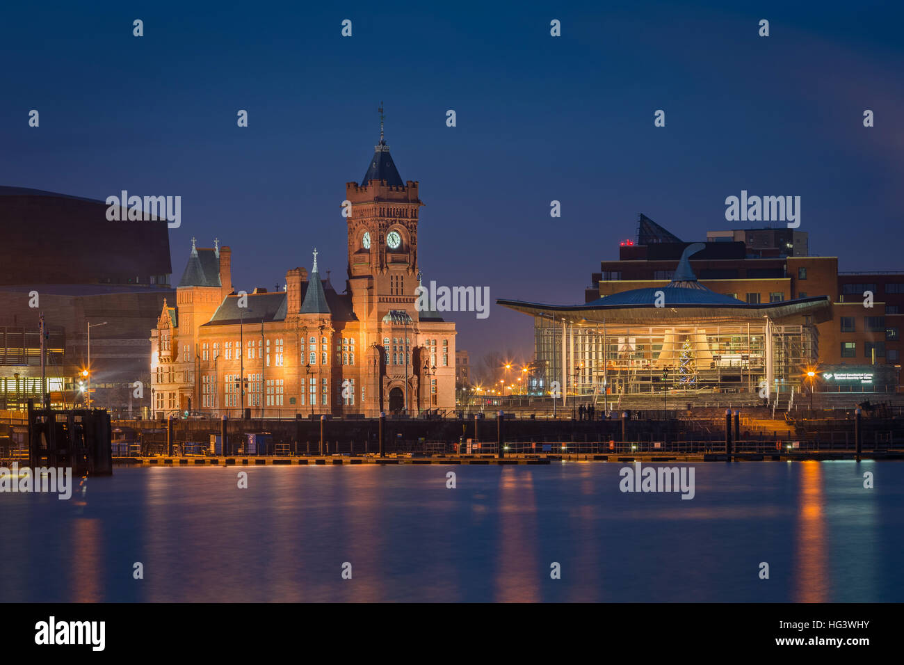 Pierhead building and Y Senedd (Welsh Assembly building) lit at night, Cardiff Bay, Glamorgan, Wales, UK Stock Photo