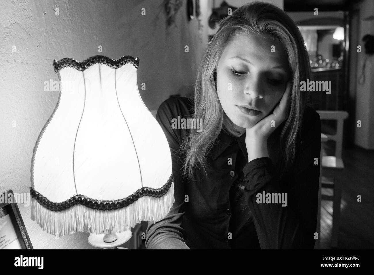 Monochrome portrait of a young woman taken in a tea room Stock Photo