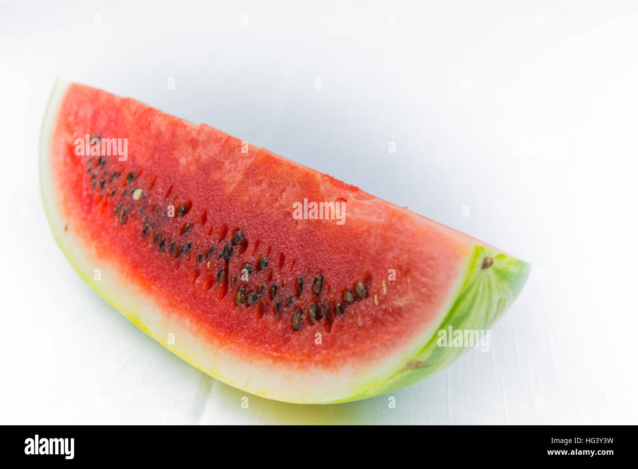 Watermelon cut in half or in segments.Typical half-moon. Sicilian or Mediterranean summer fruit. On white background Cut. graphic resource. Stock Photo