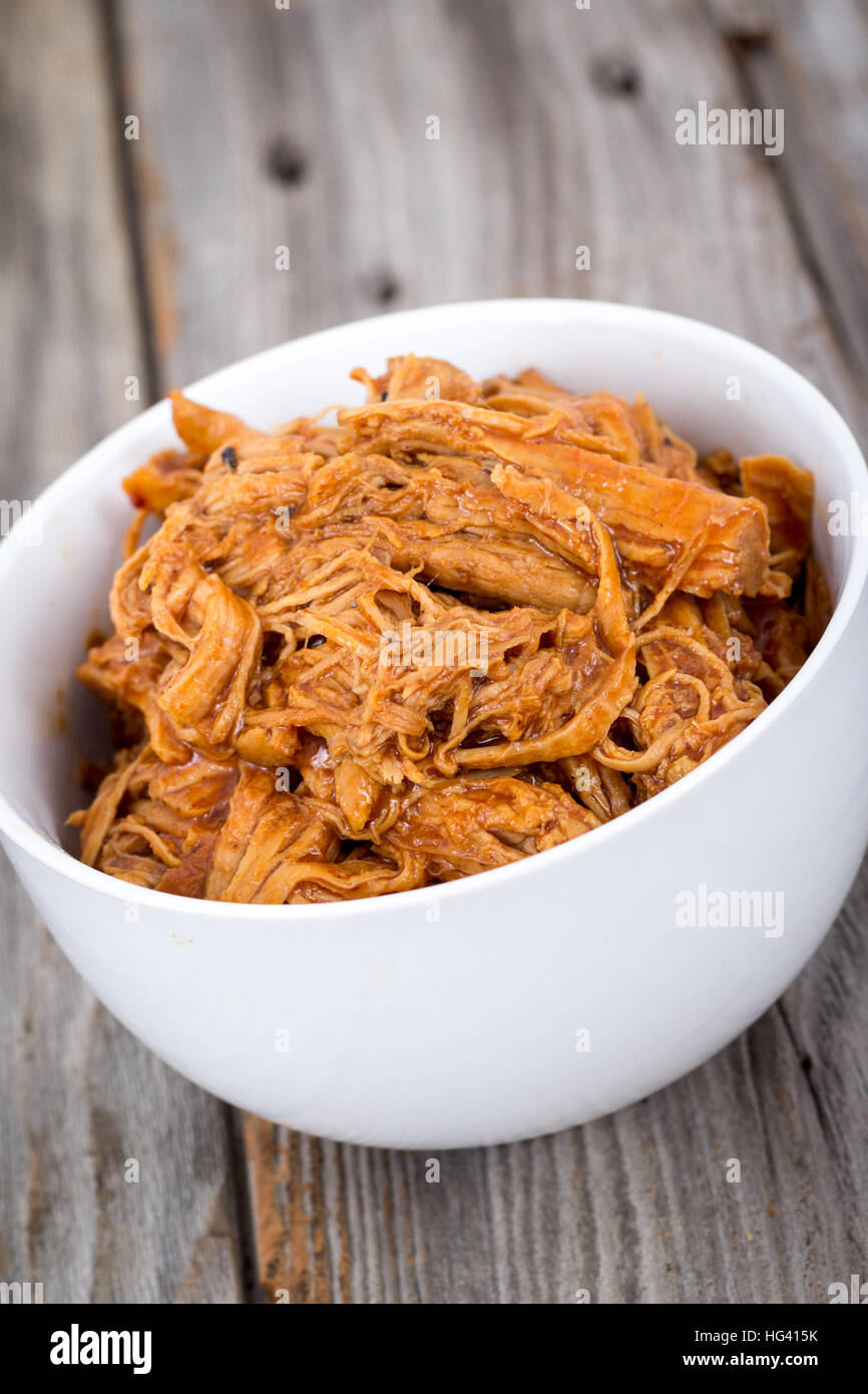 bbq pulled pork bowl over a wooden plank table Stock Photo