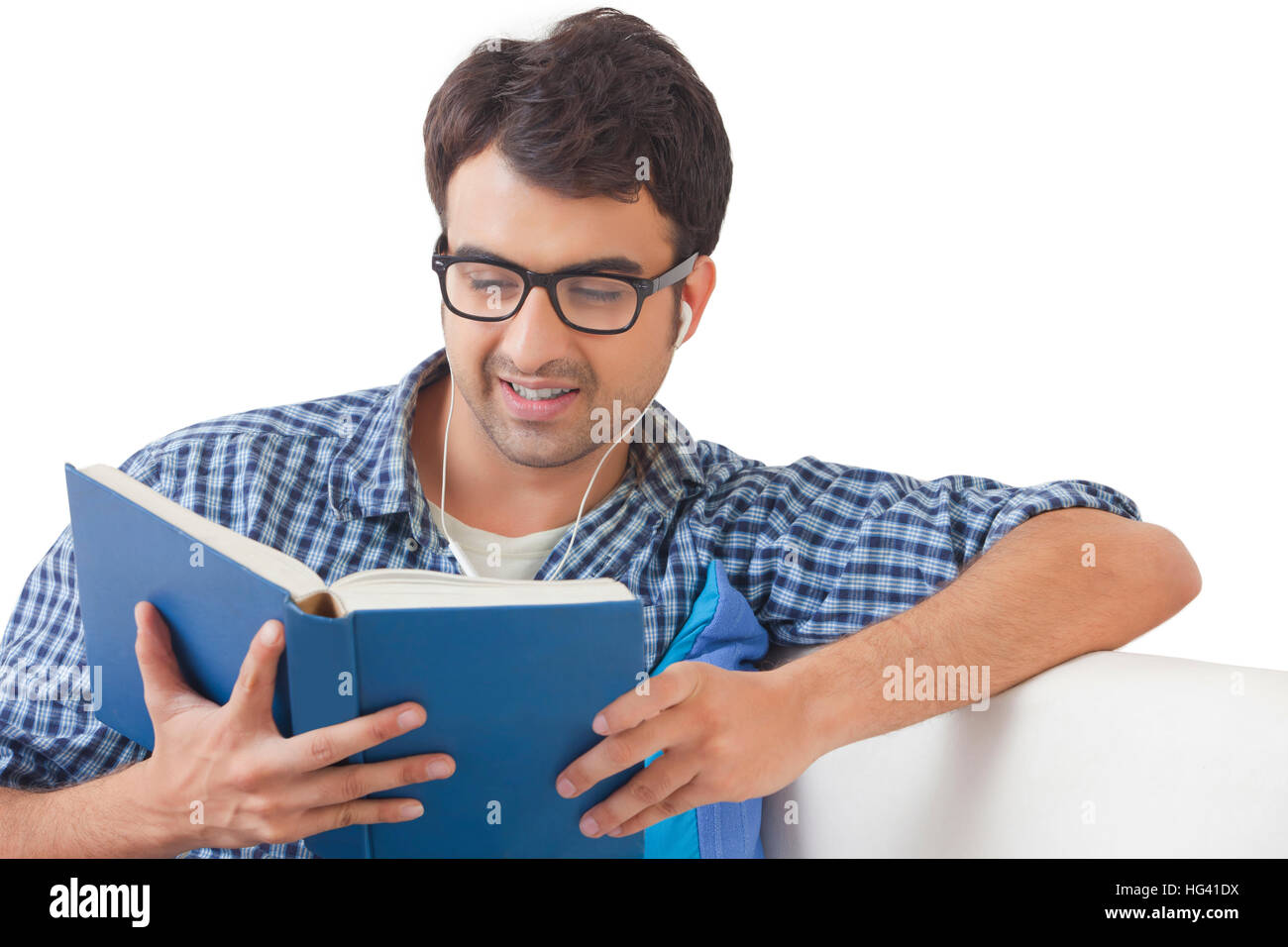Young man reading book and listening music Stock Photo