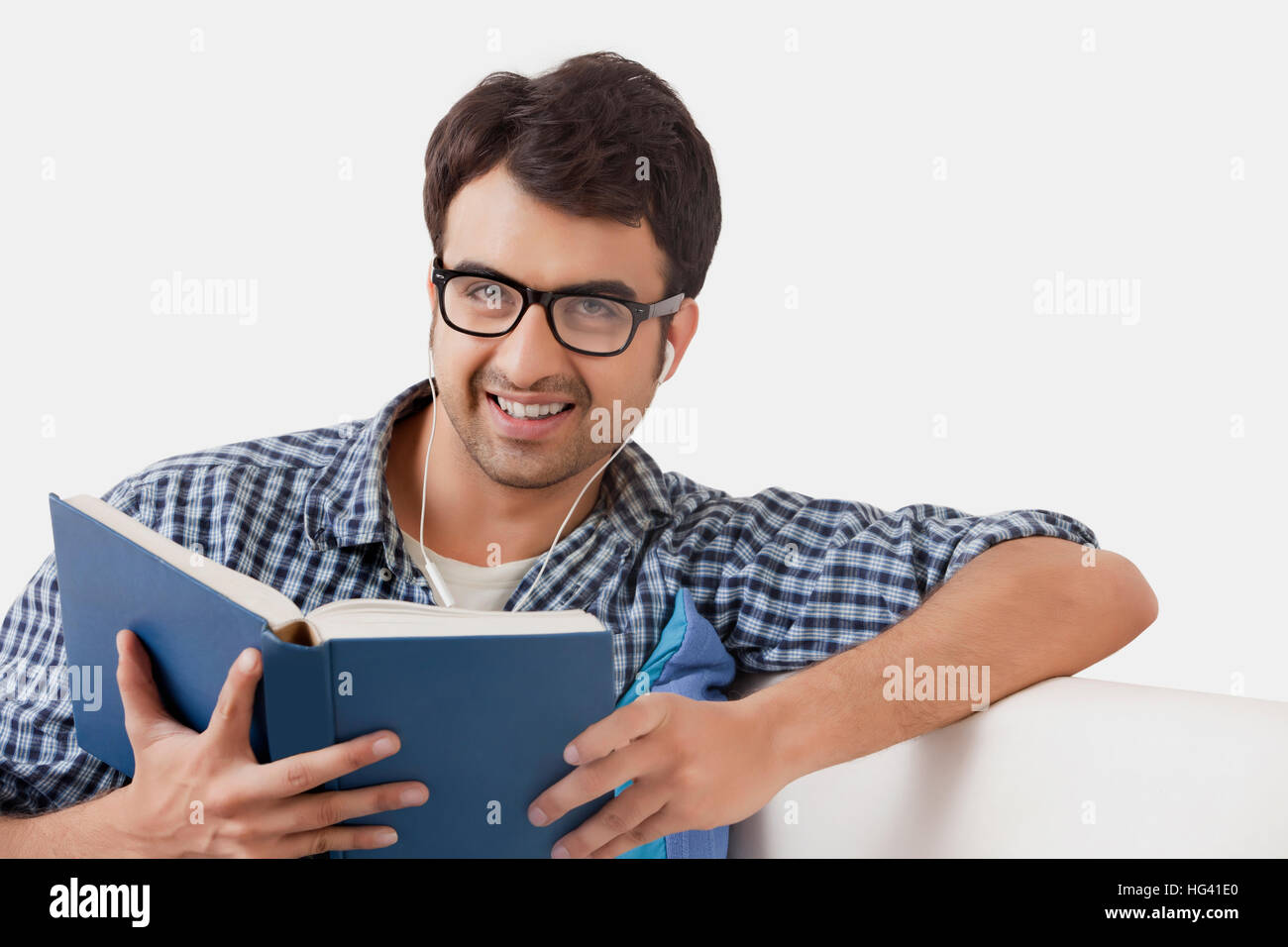 Young man reading book and listening music Stock Photo