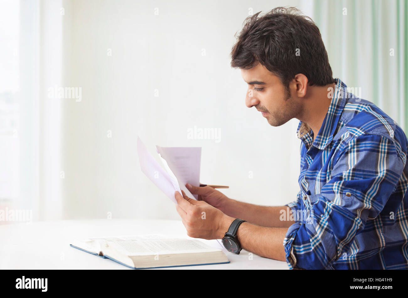 Young man studying and making notes Stock Photo