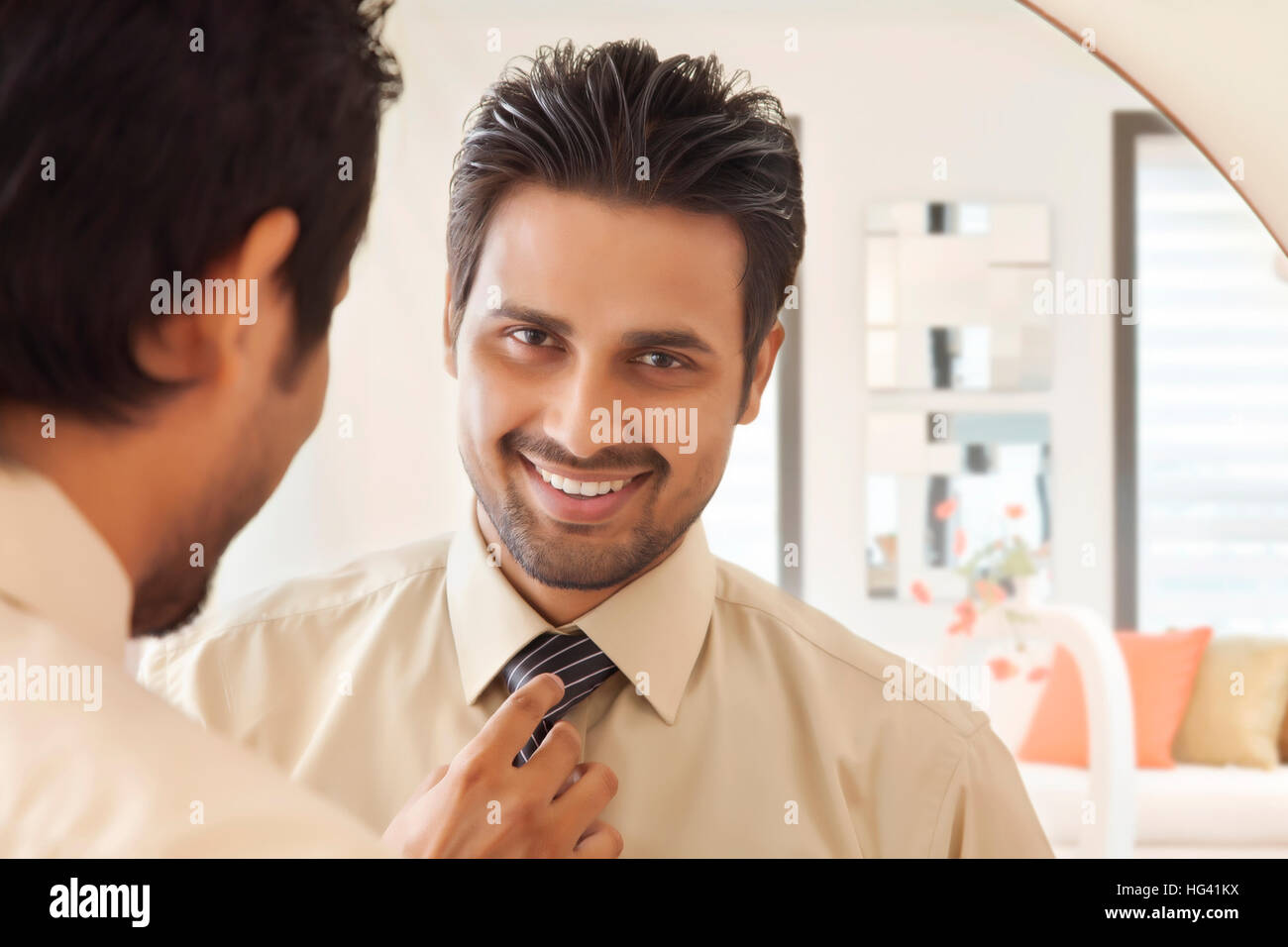 Businessman looking at self in mirror Stock Photo